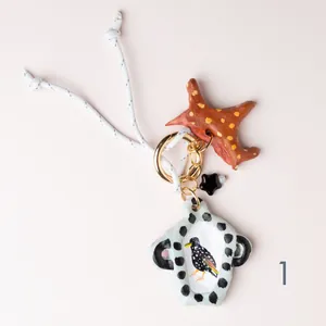 Exquisite hand-painted bird and star ceramic charm keychain for stylish bag decoration