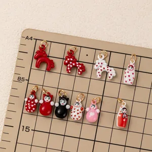 Detailed macro view showing various colorful DIY doll and animal charms on a grid board