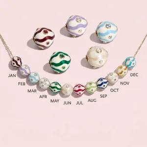 Macro detail view of colorful birthstone charms necklace with swirl wave patterns