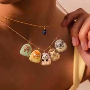 Detail view of cute animal sleeping bag pendants including bear and panda charms.