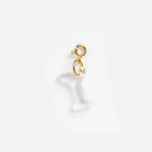 Detailed macro view of a translucent frosted resin cocktail glass charm with gold spring clasp