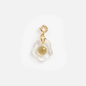 Detail of a creative resin fried egg pendant with a gold-plated stainless steel clasp.