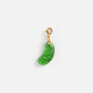 Macro view of a unique green pickle-shaped resin charm with golden stainless steel clasp