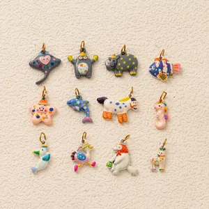 Close-up detail of 12 distinct animal enamel charms featuring intricate printed patterns