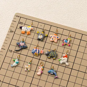 Detailed view of colorful animal charms on a measuring grid for DIY jewelry making