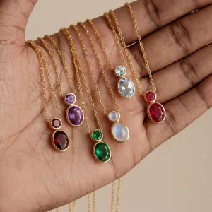 Detailed close-up showing a variety of multi-colored double-gemstone necklaces in a palm