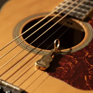 Detailed macro shot of a 18K gold-plated guitar-shaped pendant on guitar strings