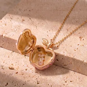 Elegant pink and gold apple locket necklace featuring a delicate ballet slipper charm