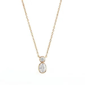 Close-up of minimalist rose gold necklace featuring a bezel-set round and oval crystal pendant
