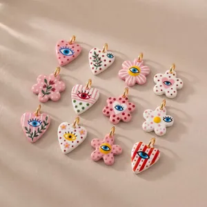 Detail view of colorful heart and flower evil eye pendants for DIY jewelry making