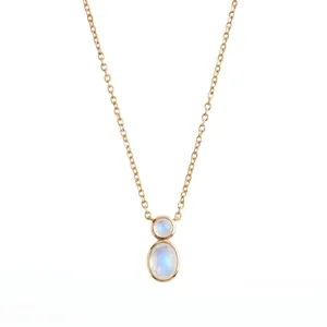 Close-up of a minimalist gold gourd necklace with dual moonstone bezel-set pendants.