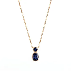Detail of rose gold necklace with double oval blue gemstones in bezel setting