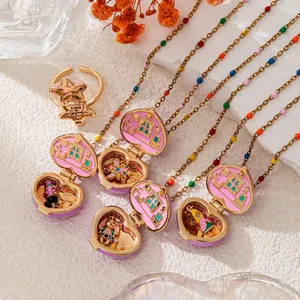 Close-up of heart-shaped locket necklaces with miniature colorful tiny home scenes