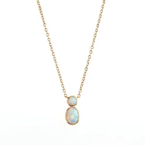 Detail of an elegant rose gold necklace with two oval iridescent opal gemstones