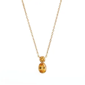 Gold bezel-set citrine double stone pendant necklace showing fine chain details and luster.