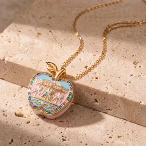 Close-up of pink gold apple locket necklace with colorful carousel carousel detail