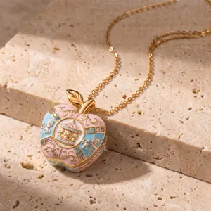 Detailed view of a pink apple locket necklace featuring a golden carousel motif