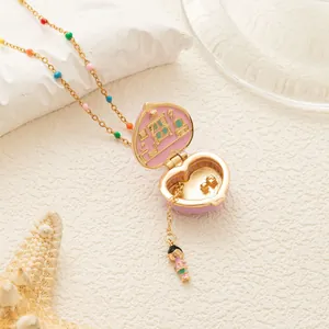 Close-up of pink heart locket necklace opening to reveal a miniature room interior
