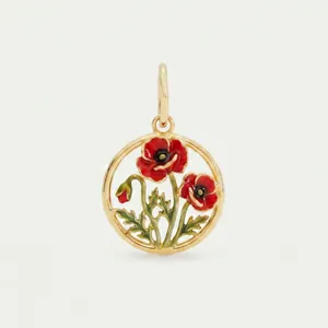 Close-up macro shot of a stainless steel gold-plated poppy flower enamel pendant.