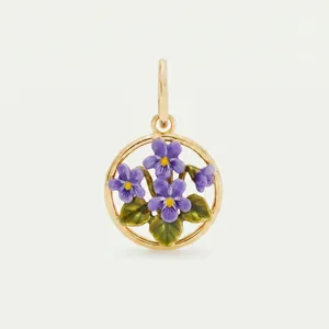 Close-up of a circular stainless steel pendant featuring purple enamel violet flowers
