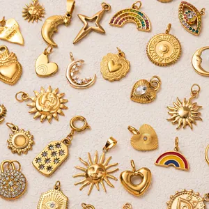 A variety of gold-plated stainless steel charms with celestial and heart motif details.