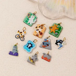 Collection of various colorful sports-themed enamel cat charms with 18K gold plating