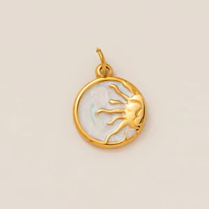 Macro view of a gold-plated sun and moon enamel jewelry pendant made of stainless steel