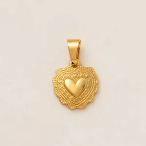 Detailed macro view of a golden stainless steel heart pendant with intricate embossed patterns