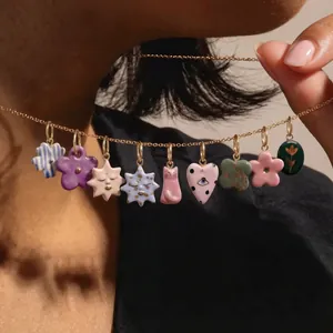 Colorful enamel charm necklace featuring hand-painted flowers, hearts, and stars design.