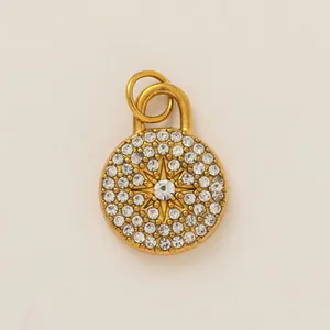 Close-up of gold stainless steel circular pendant with rhinestone starburst design