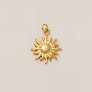 Close-up macro view of a golden sunburst pendant with polished curved rays for DIY jewelry.