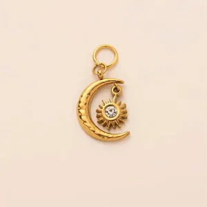 Close-up detail of a vintage gold sun and moon pendant with a central sparkling crystal