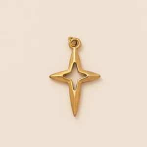 Detailed macro shot of a gold-plated four-pointed star pendant with center cutout