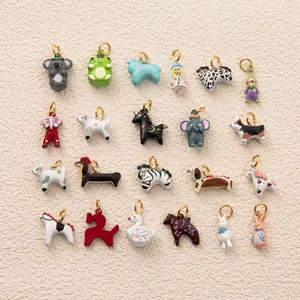 Collection of various colorful enamel animal charms neatly arranged for DIY jewelry crafting.