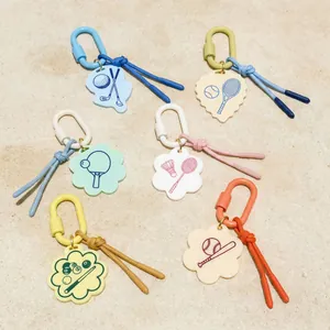 Colorful sports-themed keychains featuring golf, tennis, and badminton icon pendants.