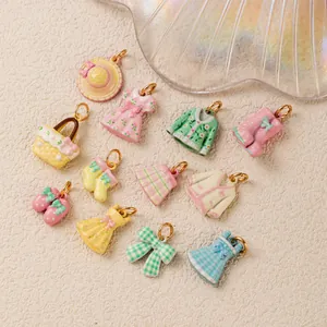 Collection of pastel enamel clothing charms like dresses and boots for DIY jewelry