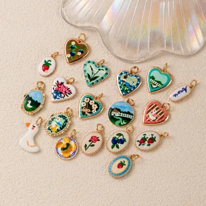 Detailed view of pastoral style hand-painted charms with floral and animal motifs