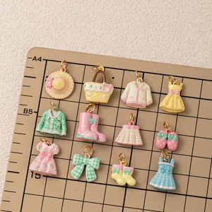 Detail view of assorted enamel clothing and accessory charms for DIY jewelry making