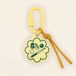 Detailed close-up of yellow flower-shaped billiards themed keychain with brown cord detail
