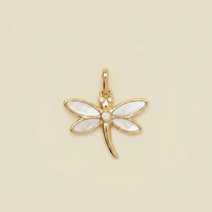 Detailed view of a gold-toned dragonfly pendant with pearl wings and crystal accents.