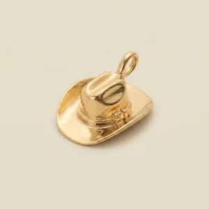 Detailed macro view of a polished gold-plated cowboy hat pendant for stylish necklaces