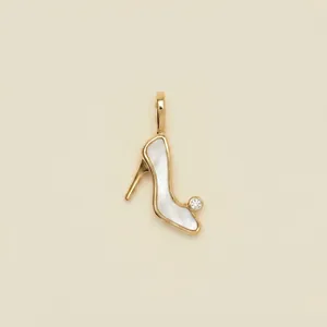Detailed view of high heel shoe charm pendant with white pearl inlay and gold finish