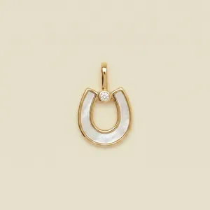Elegant gold horseshoe pendant featuring white mother-of-pearl inlay and single diamond