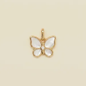Detailed view of a gold-toned butterfly pendant featuring elegant shell wing inlays