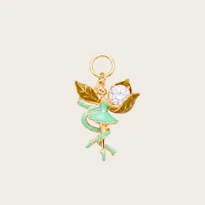 Detailed close-up of a fairy ballerina pendant featuring green enamel and a clear gemstone