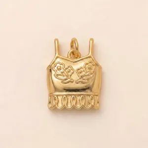 Detailed view of a gold-plated stainless steel camisole charm with floral accents.