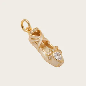Exquisite close-up of a pink enamel ballet shoe pendant with shimmering crystal accents