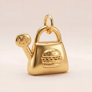 Detailed view of gold 18K plated pendant with unique hamburger and heart motifs.