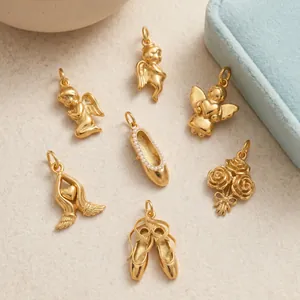 Detail shot of various 18K gold plated angel and ballet shoe charms for jewelry
