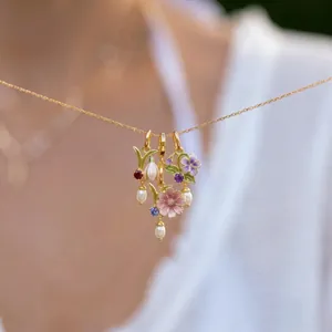 Macro detail of elegant floral bouquet pendants with colorful enamel and assorted birthstones